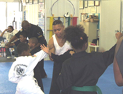 Guest Instructor Sifu Walker instruct students in the proper way to block a blow.
